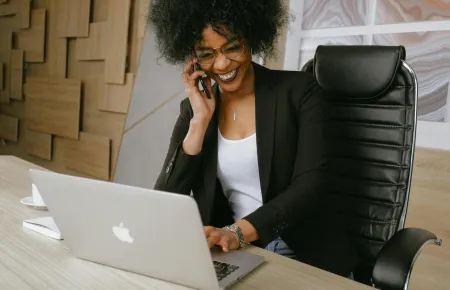 A professional woman smiling and speaking on the phone | Securing a new job
